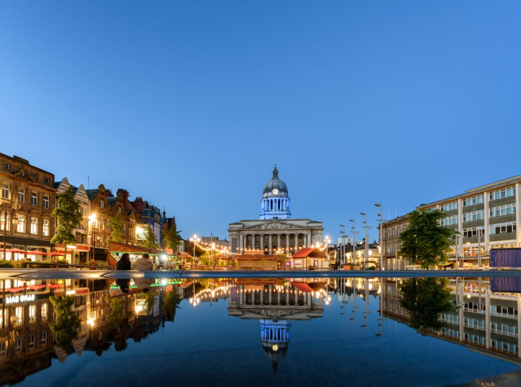 The front of Nottingham Town Centre, behind a body of water.